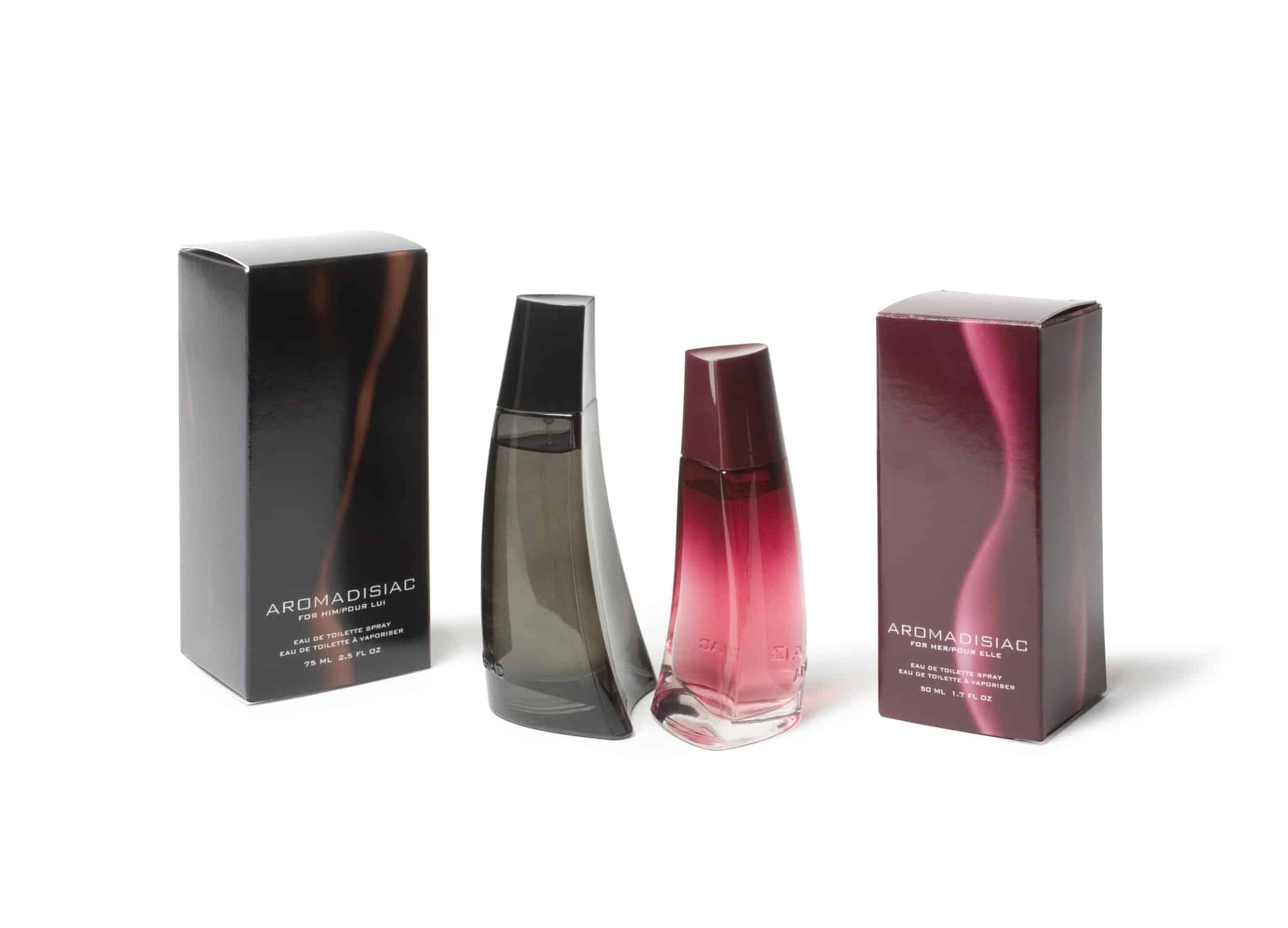 Avon Aromadisiac fragrance product packaging boxes in pink ombre for her and translucent black for him.