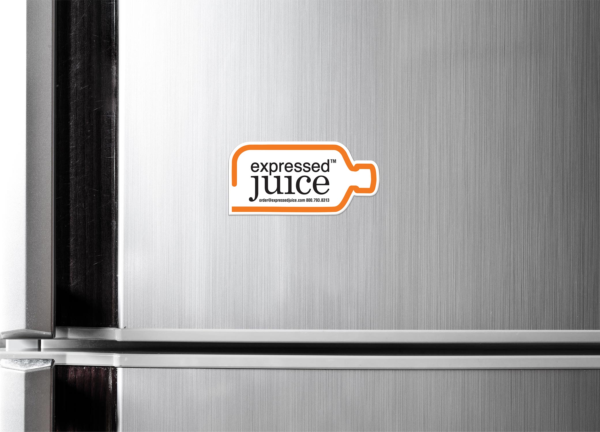 Expressed Juice magnet displayed on stainless steel refrigerator with logo and orange outline of a bottle shape.