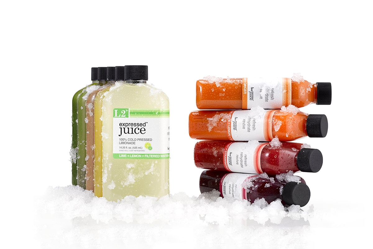 Expressed Juice award winning packaging showcasing different types of flavors and bottle shapes laying on a layer of crushed ice.