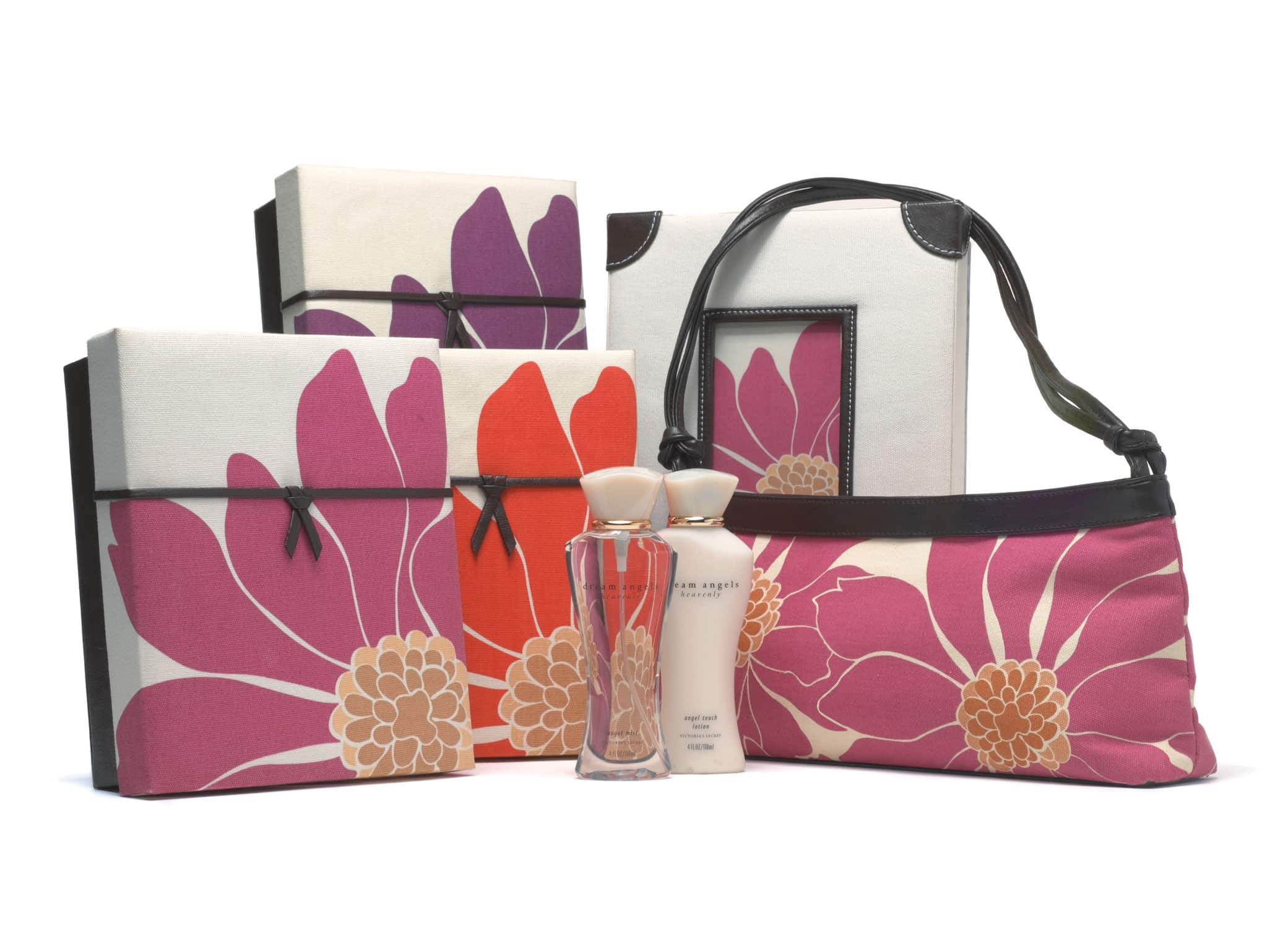 Custom gift box packaging design for Victoria's Secret Dream Angels including fragrance bottles, boxes, and handbag with mauvey floral designs.
