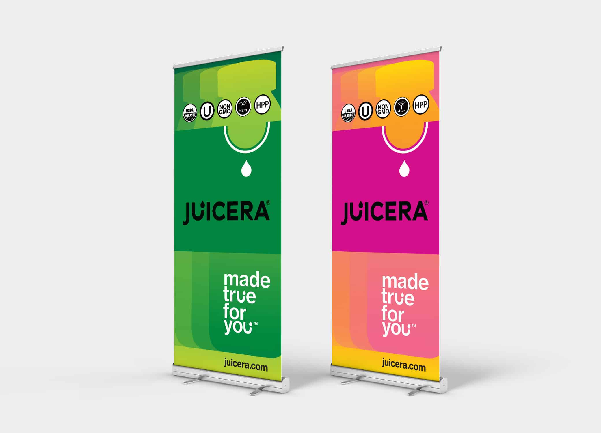 Juicera bright pink and green banners arranged next to each other against grey backdrop.