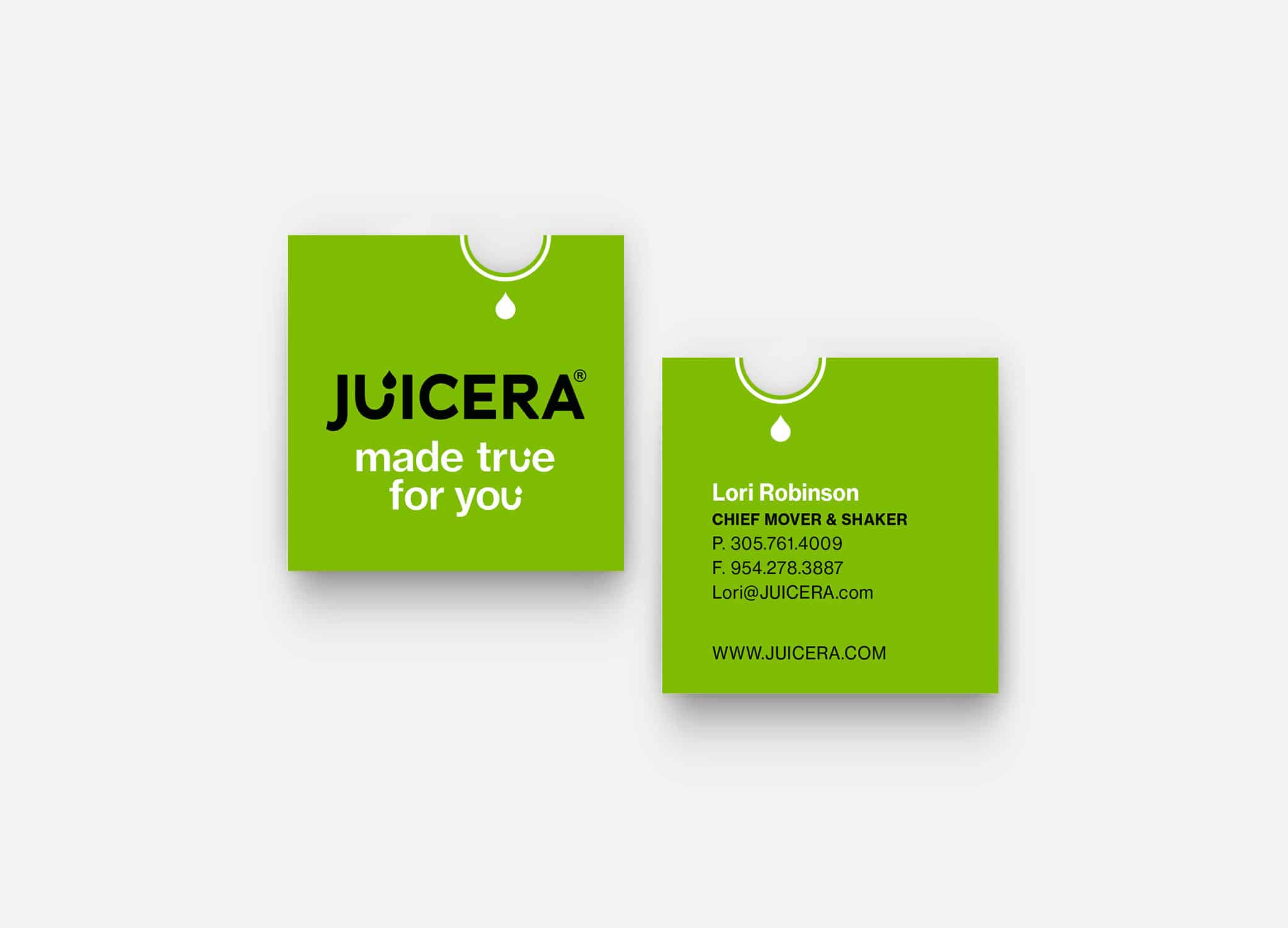 Juicera business cards front and back view in bold green with half-moon die-cut.
