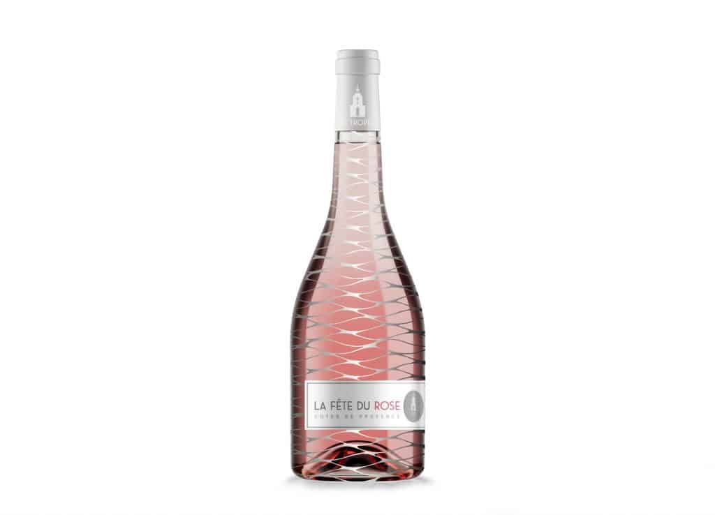 St. Tropez Rose wine bottle package design in pink with silver mesh detail and La Fete du Rose on a silver and grey label.
