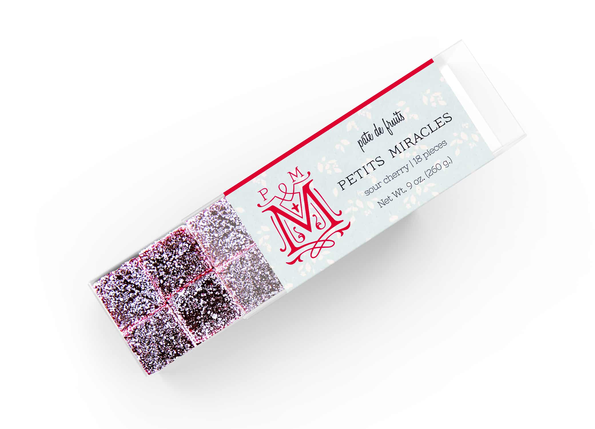 Petits Miracles packaging design with pate de fruits in the box and swirls around "M" icon next to type.