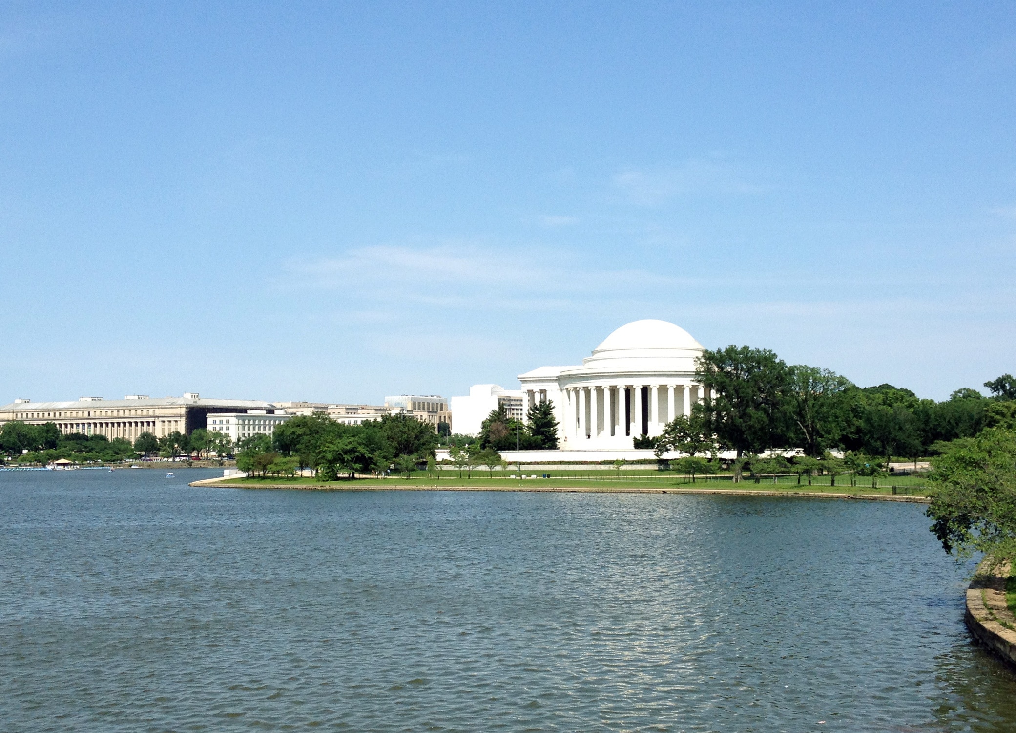 Design agency clients located in Washington DC, image showing The Capitol next to lake and trees.