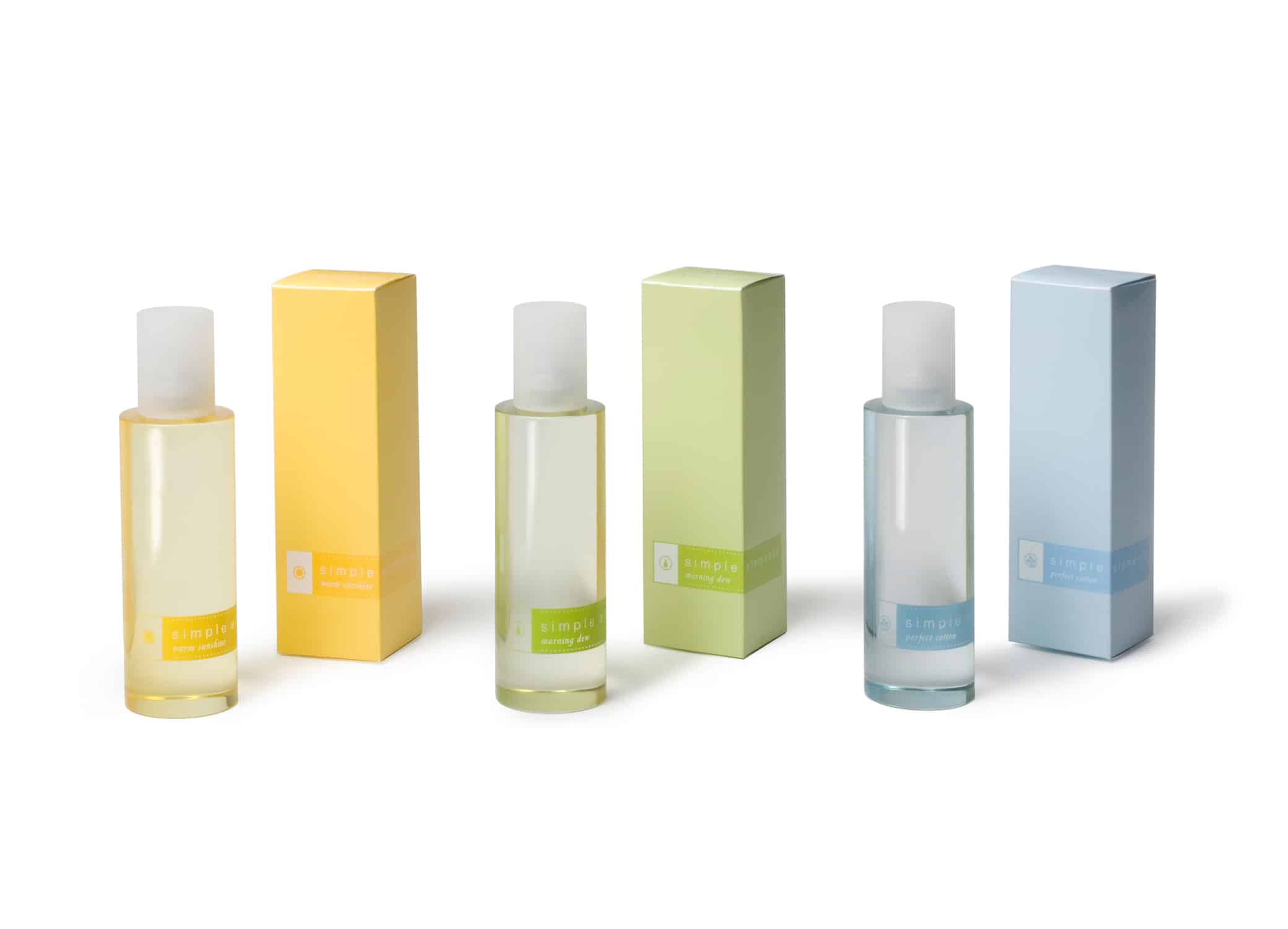 Avon Simple Elements perfume cosmetic packaging design with transparent bottles and pastel yellow, green and blue labels.