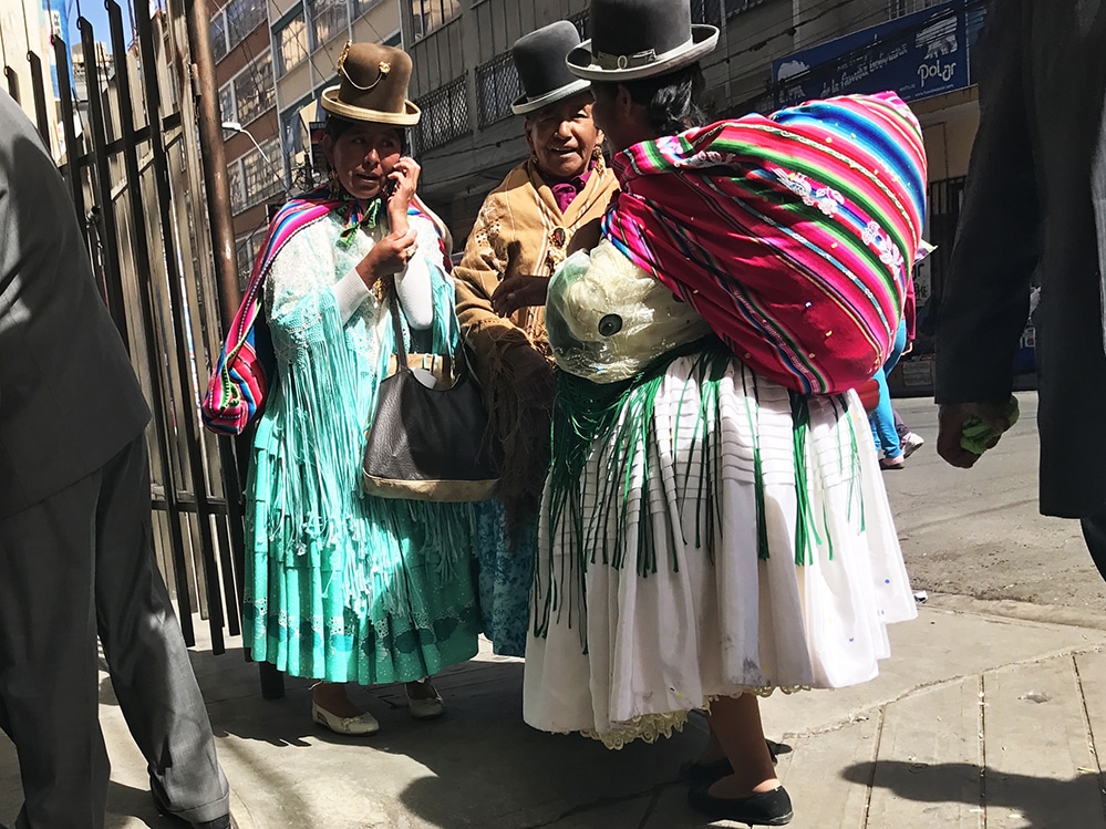 Cholita on their cell phone