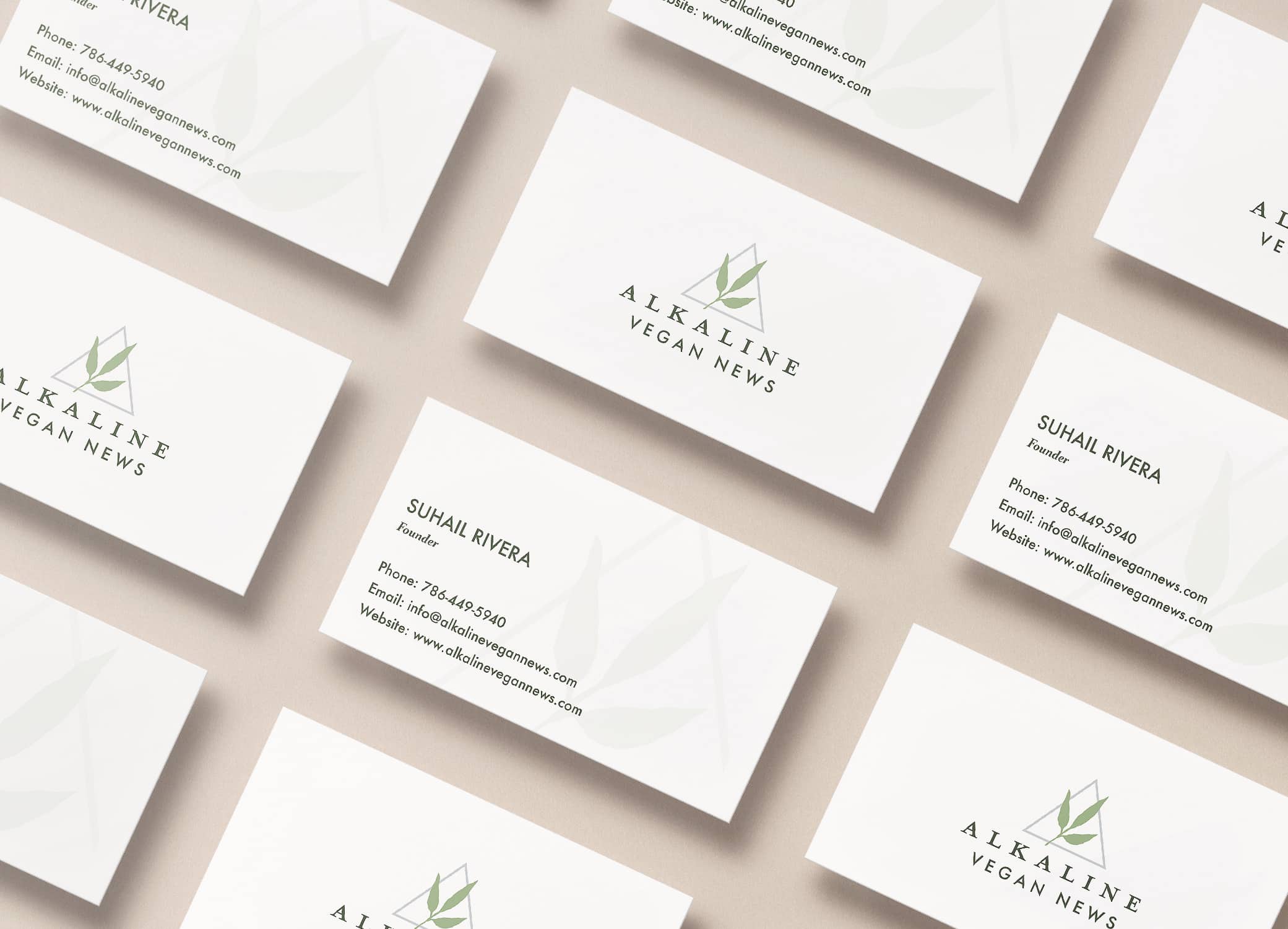 Alkaline Vegan News brand identity showing business card design with leaf logo on the front and watermark on the back.