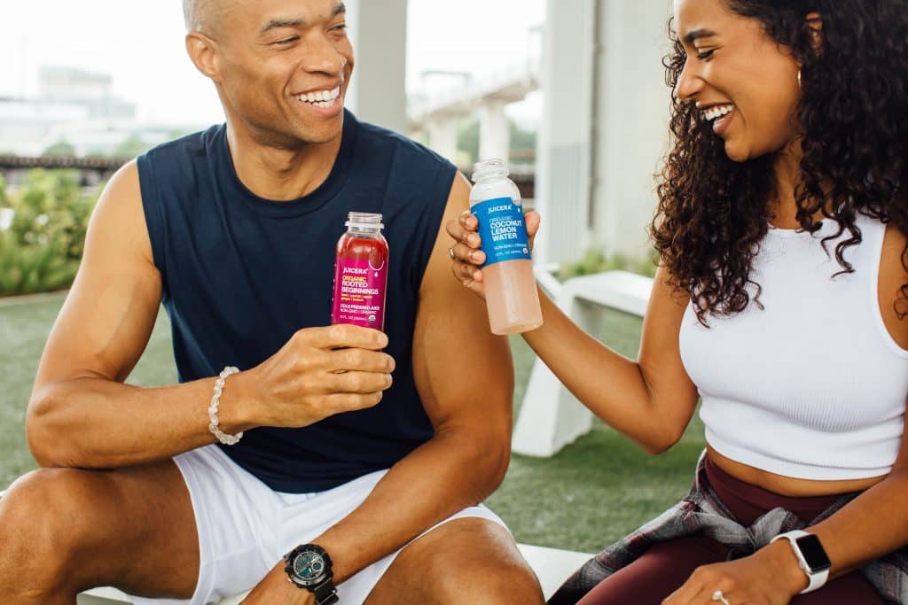 Juicera juice brand product photography of a man and a woman enjoying after a workout.