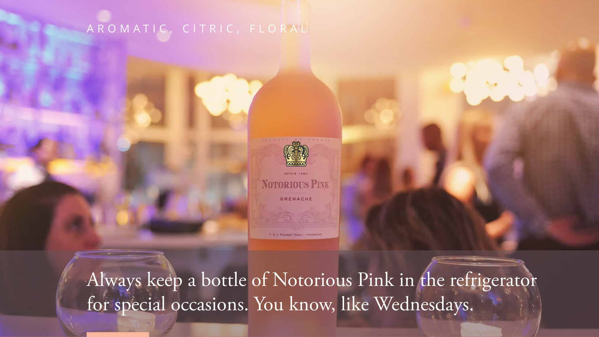 Wine branding strategy: Notorious Pink 'Affordable Luxury, Artistic and Fun' campaign showcasing their featured rosé in a dinner setting.