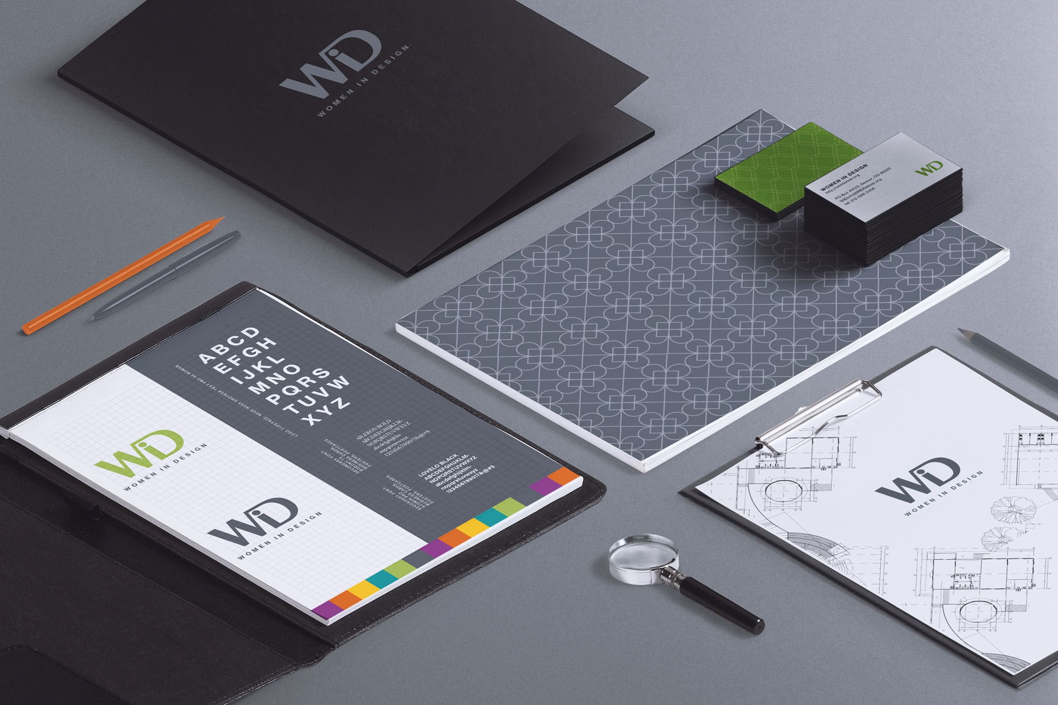 Women in Design stationary set showcasing business cards, folders, clipboard and other office utensils.