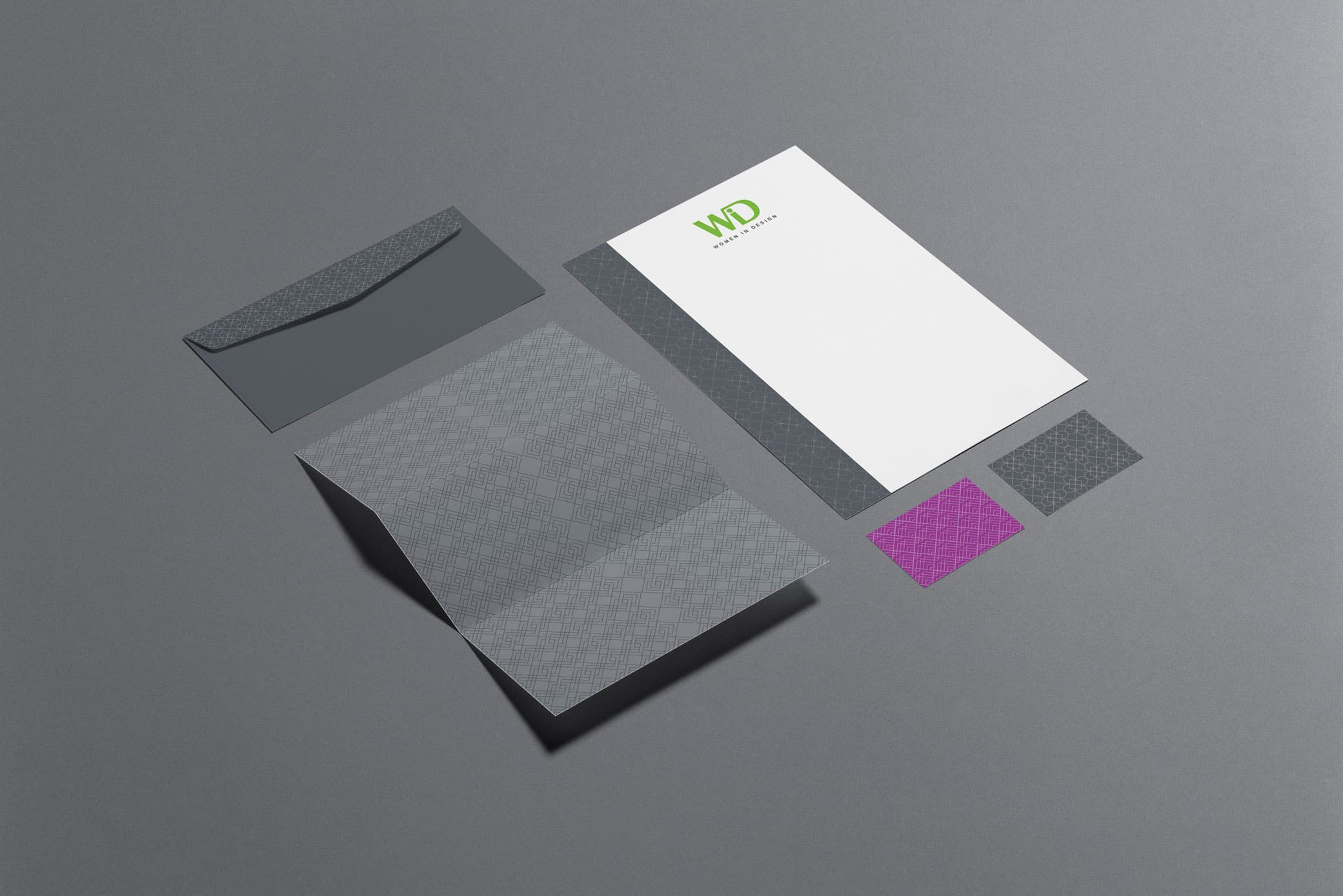 Women in Design stationary set showcasing business cards, envelopes, paper and other office utensils.