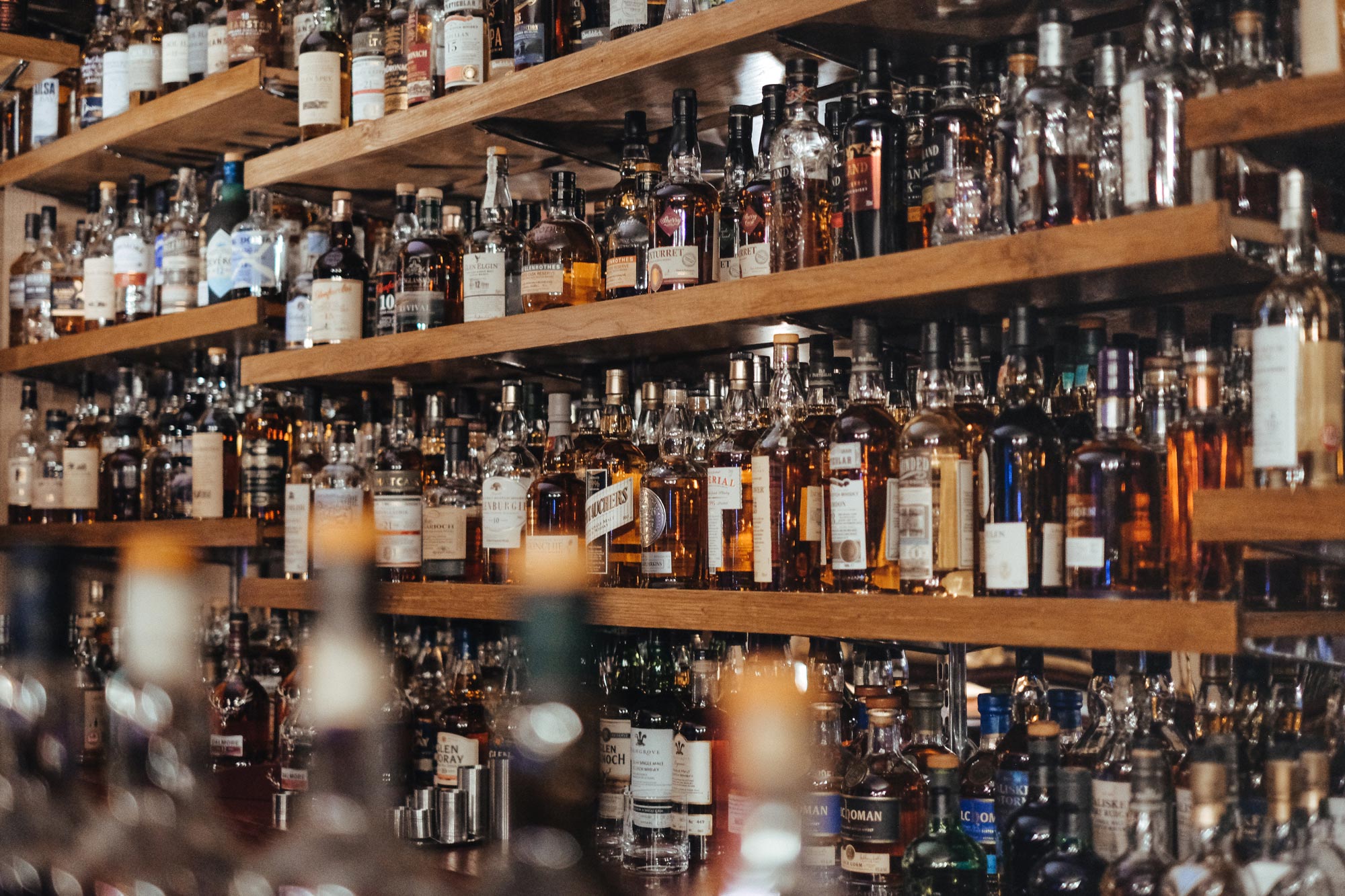 Snapshot of a bar with various liquor options displayed.