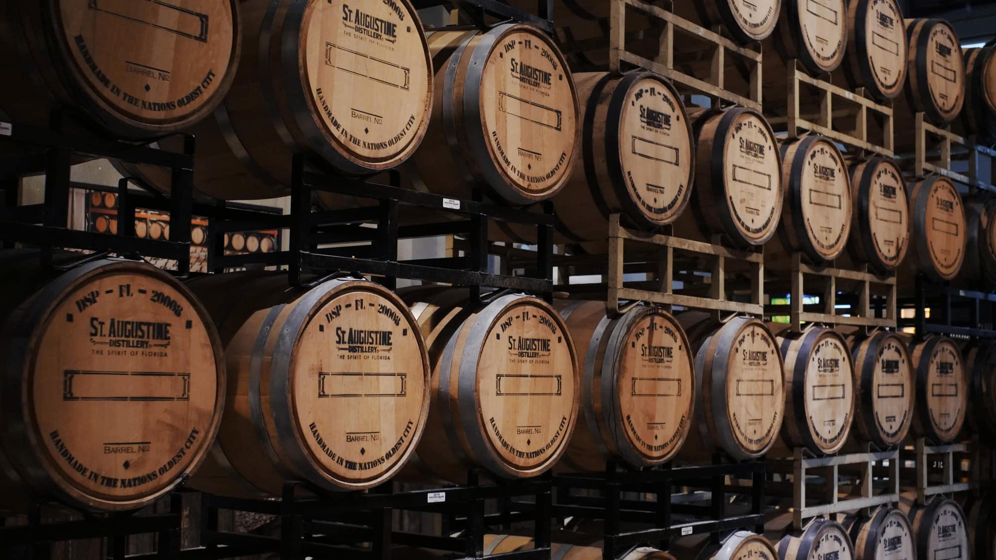 Distillery with barrels of alcohol lined up.