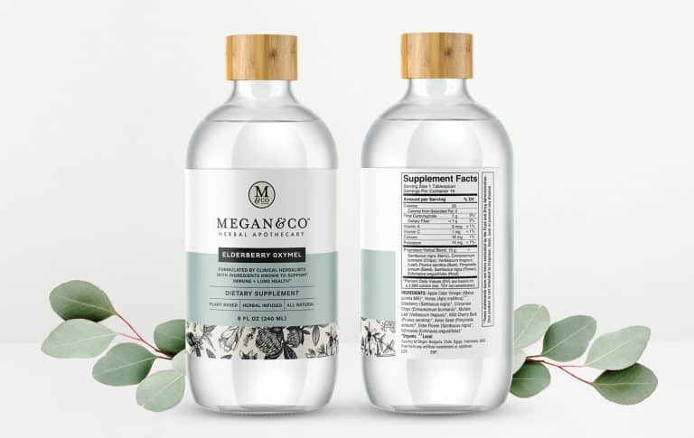 Two Megan & Co herbal apothecary packaging on light background with plants around. One bottle facing forward and one back.