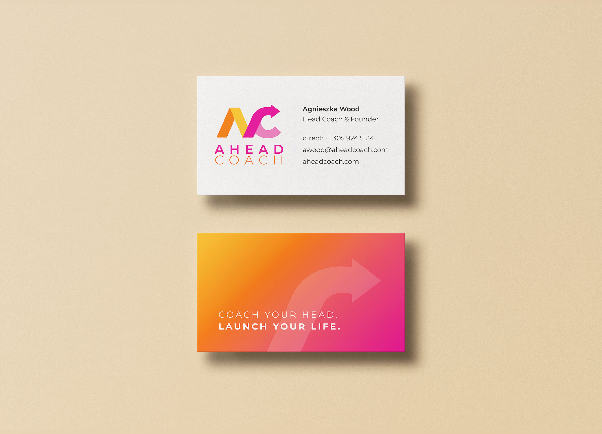 Ahead Coach business cards with logo inspired by mood boards arranged on a light peach backdrop.