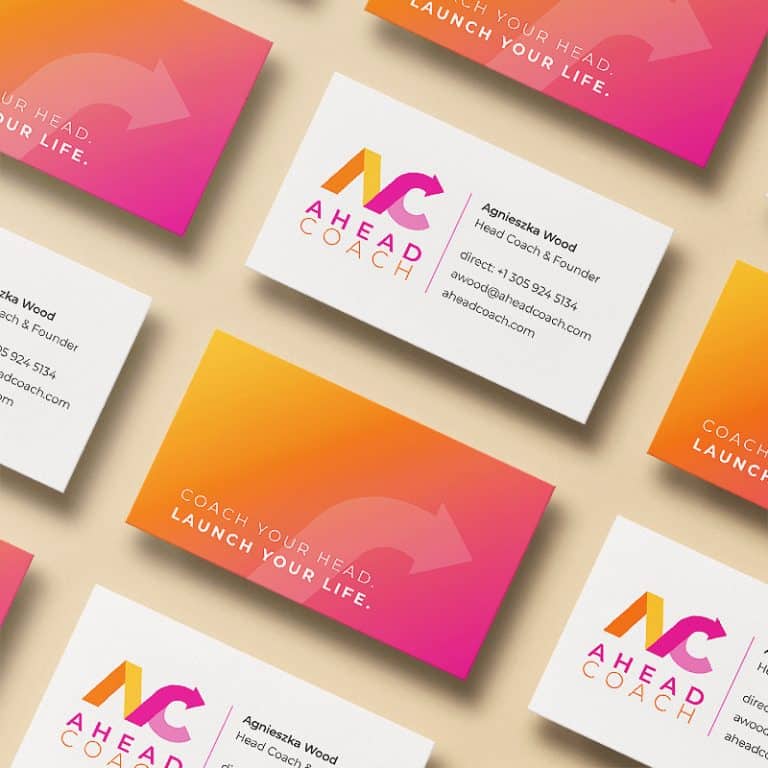 Ahead Coach business cards arranged in diagonal rows to show front and back view against a light peach backdrop.