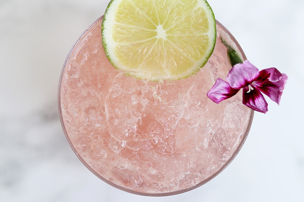 A top view of a glass showing a healthy cold drink with a slice of lime.