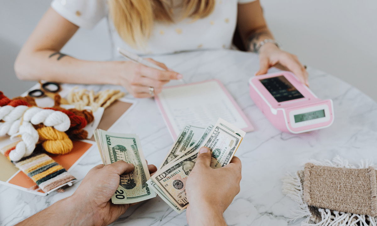 Two business entrepreneurs discussing finances and handling money for funding a product. 