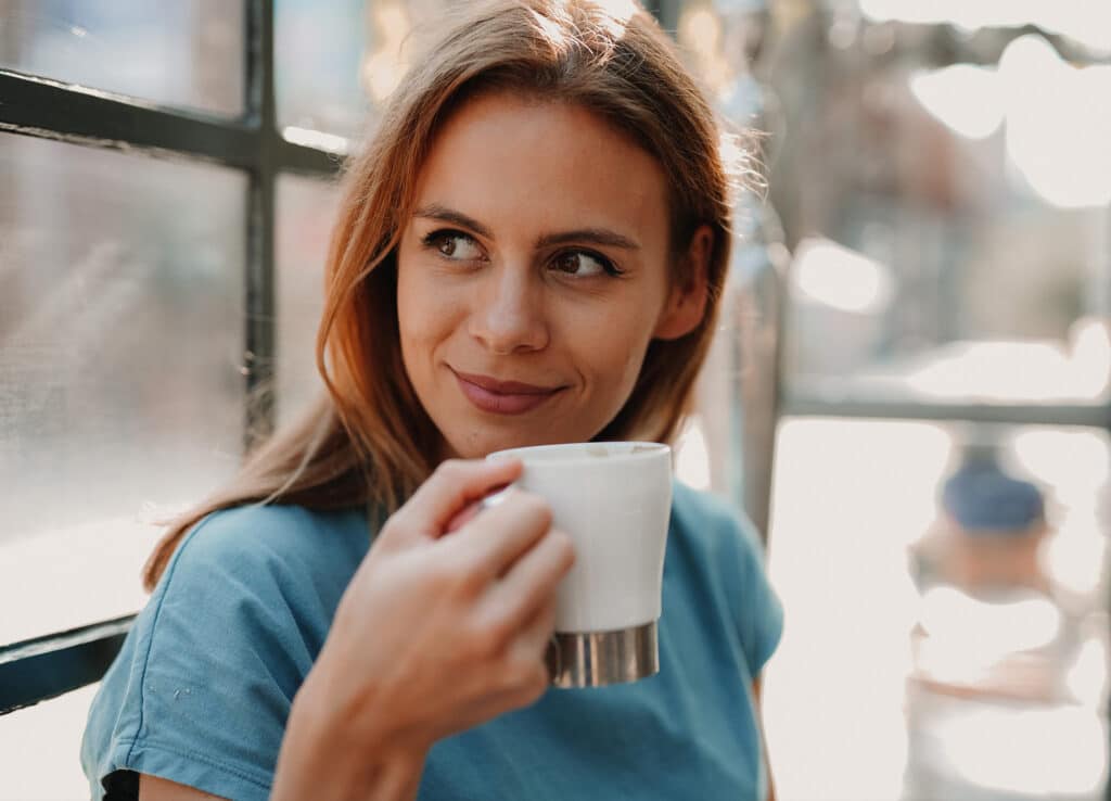 How to avoid burnout as an entrepreneur: Indulge guilty pleasures. Woman is enjoying a coffee