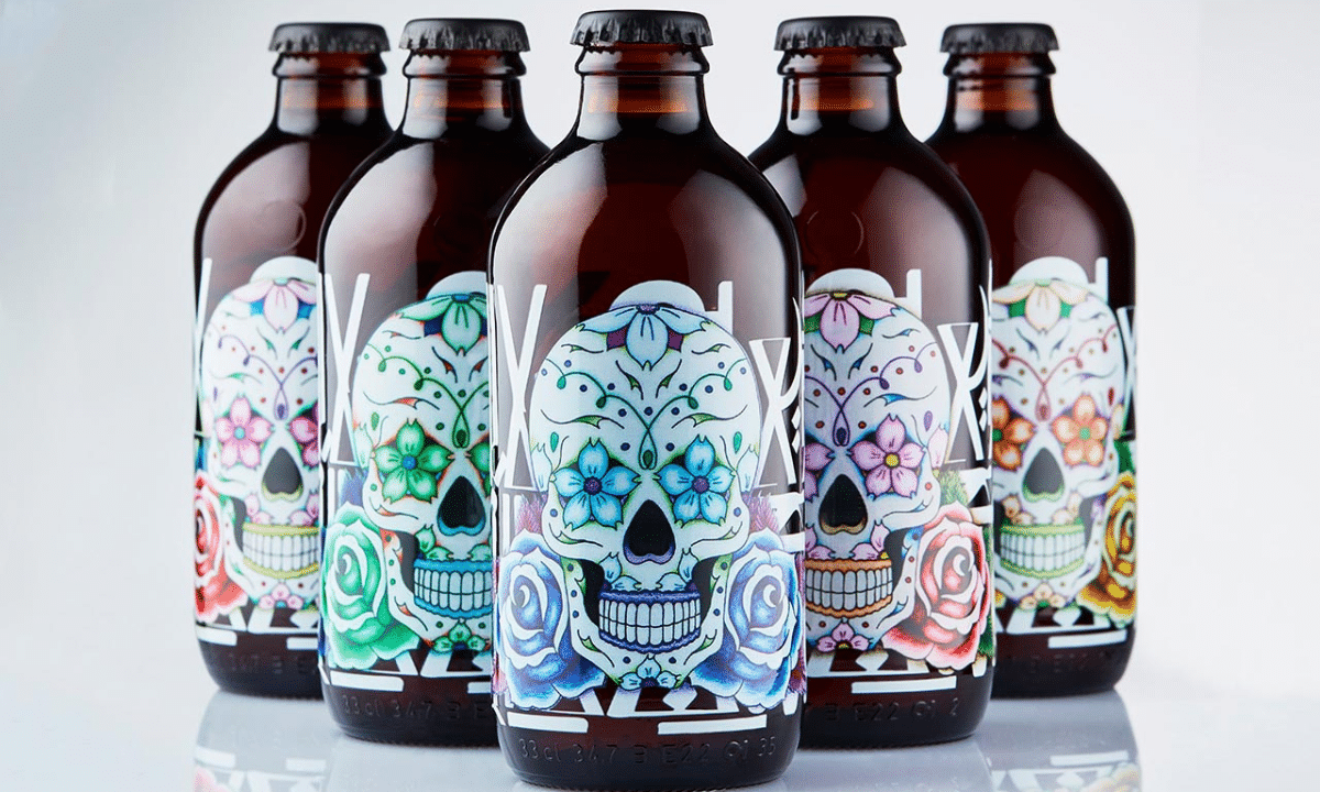 Mocktail packaging using screen printing on glass bottles with colorful skulls as the label.