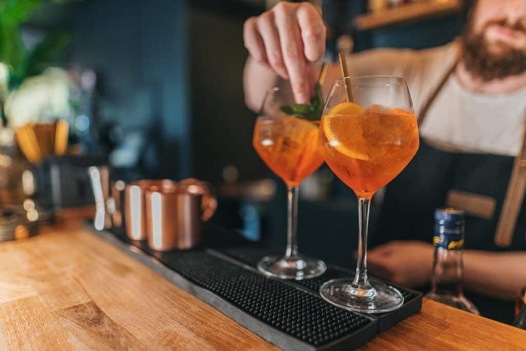 what is sober curious and what is the Future of the Beverage Industry? Man at a bar making 2 drinks.