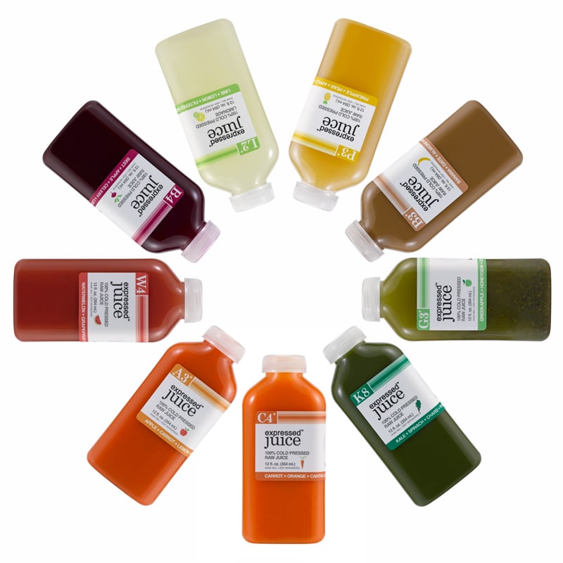 Expressed Juice bottles of different colors and flavors arranged in a circle.