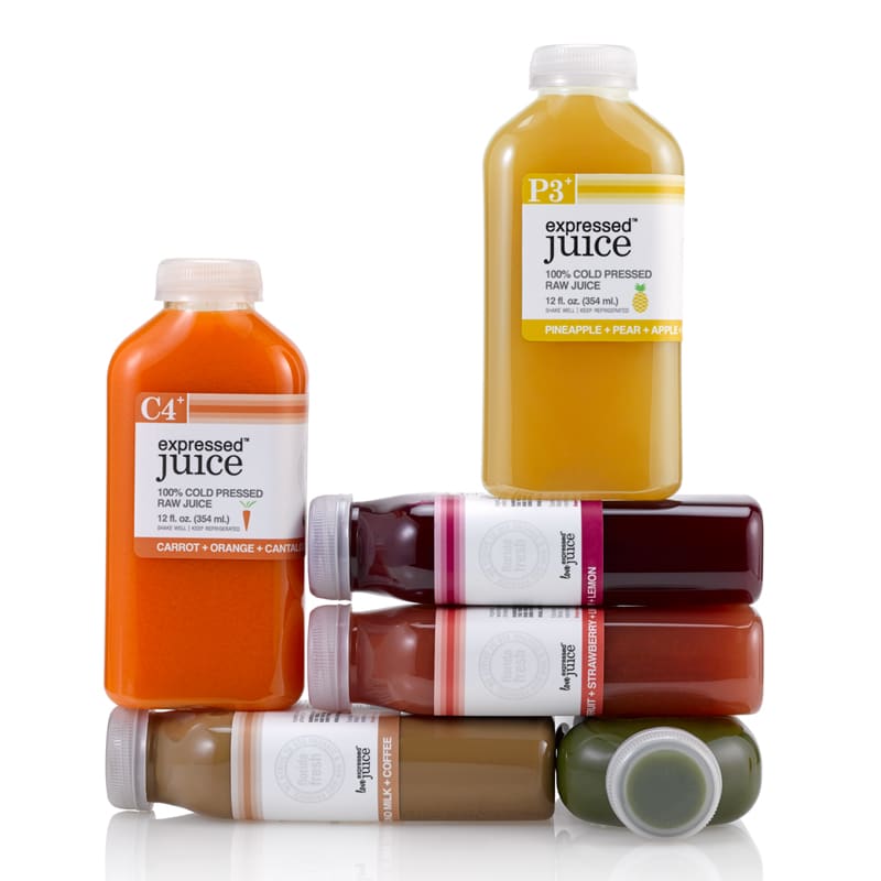 Expressed Juice stacked flask shaped bottles of different colors and flavors.