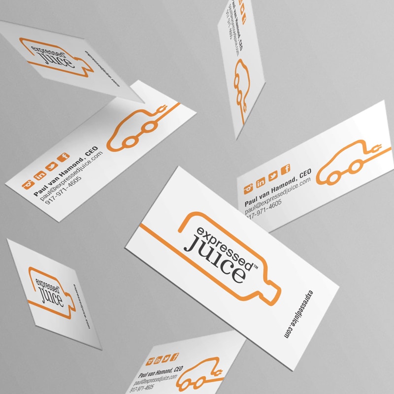 Expressed Juice free falling white business cards in front of grey backdrop with black and orange colored design and font.