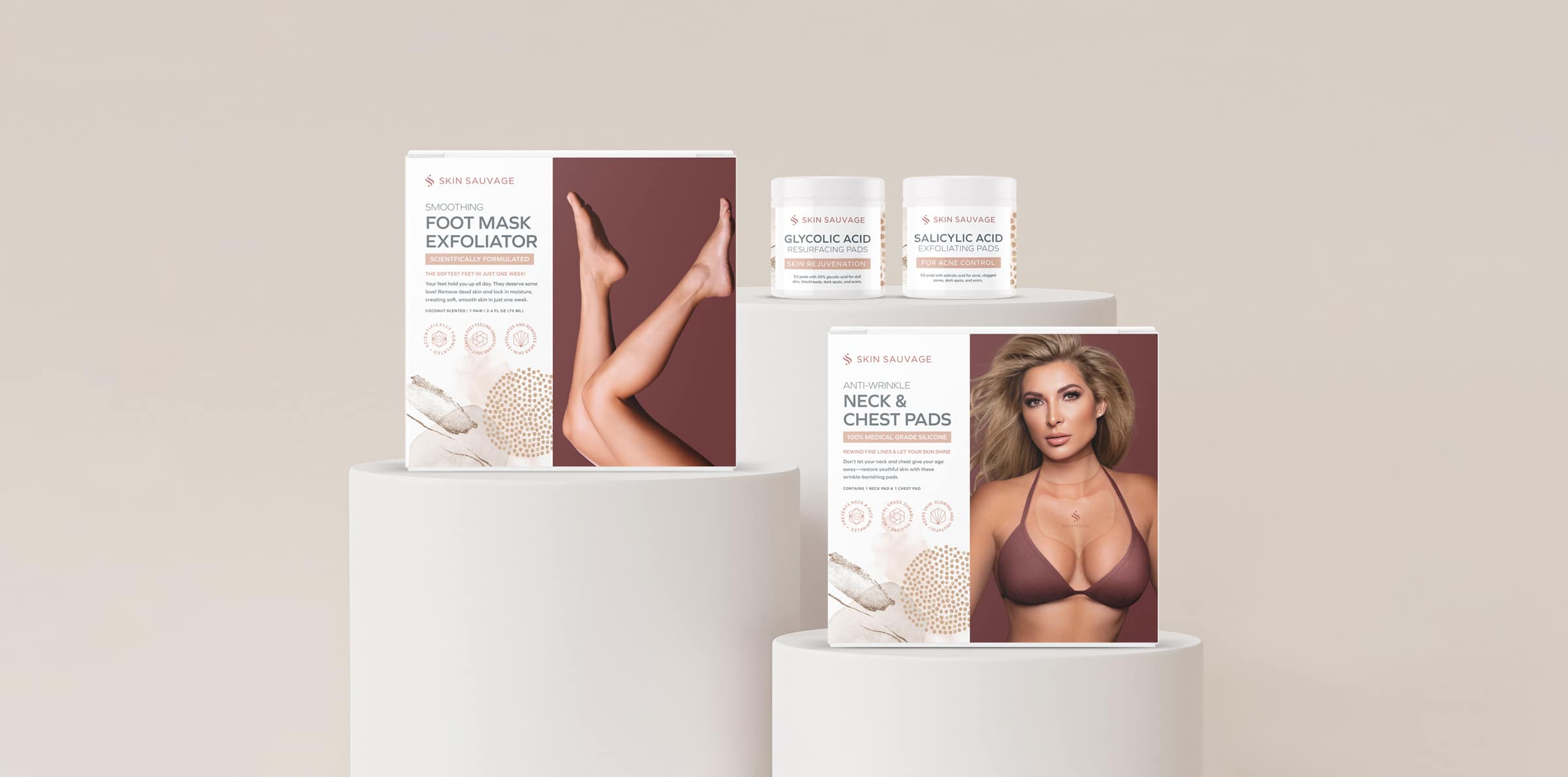 Skin Sauvage skin care packaging minimalist and displayed on three cream colored platforms.