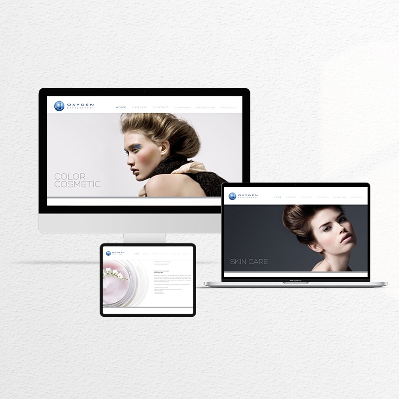 Oxygen premium website design in clean white and neutral tones showing couture makeup products and flawless skincare models.