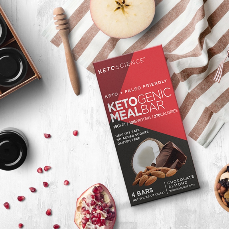 Keto Science supplement package design for Ketogenic Meal Bar, shown with pomegranate and nuts on a white background.