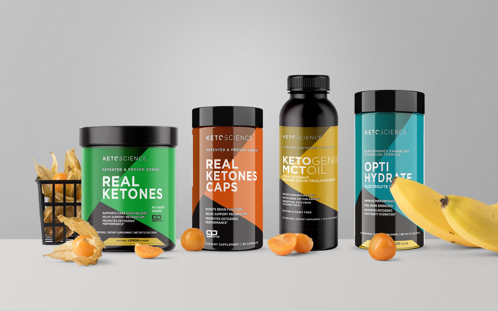 Keto Science supplement package products placed in a row with fruit against a grey backdrop.