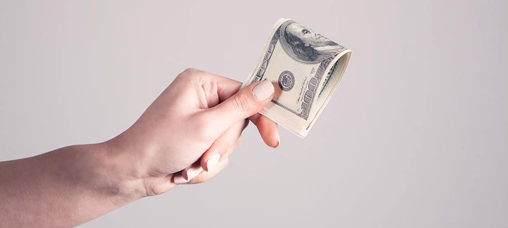 Is Your Money Mindset Hurting Your Business? - Hand Holding Money