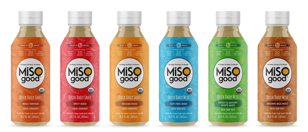 Lineup of six squeezable miso bottles that feature bright backgrounds with hand-drawn vegetable patterns in the product label